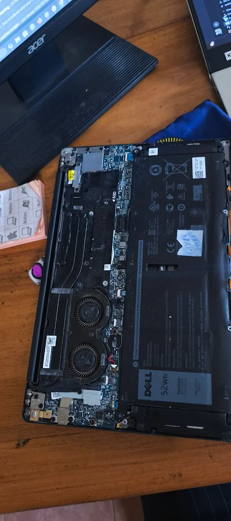 Opened laptop showing internal parts during repair work