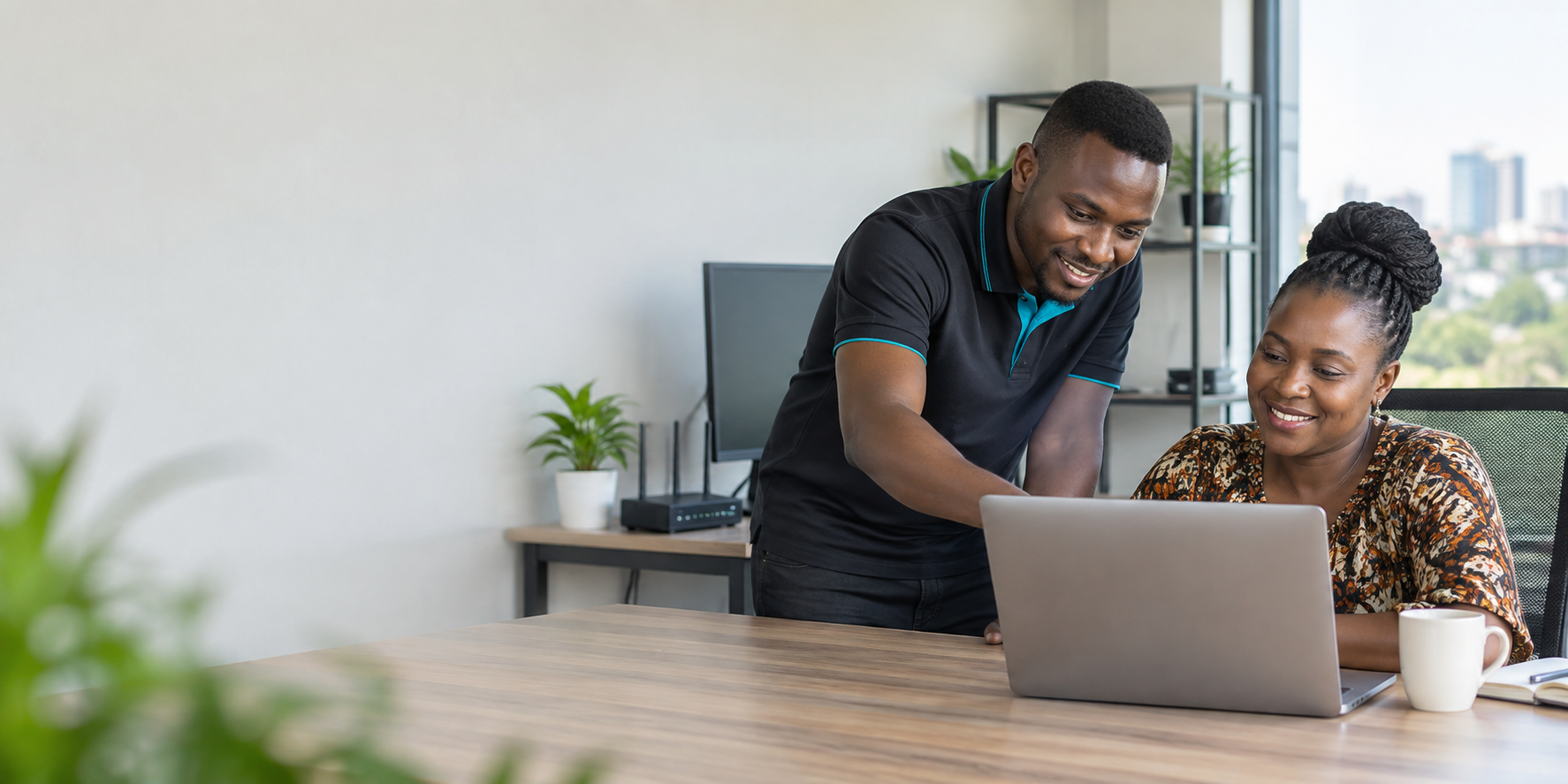 IT technician helping a client with a laptop
